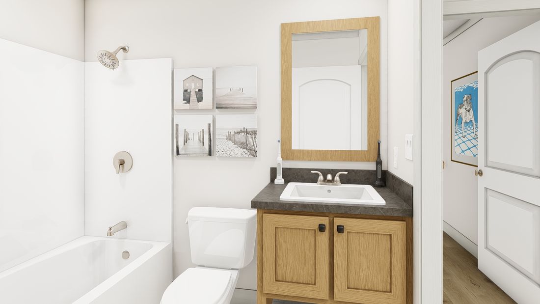 The 1676 SWEET CAROLINE Guest Bathroom. This Manufactured Mobile Home features 3 bedrooms and 2 baths.